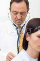 Doctor auscultating a patient