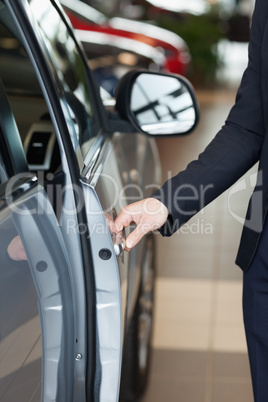 Man holding an half open door