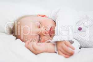 Cute baby sleeping while extending her arms
