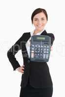 Happy businesswoman in black suit showing a calculator