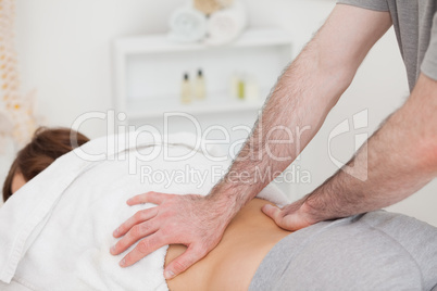 Masseur massaging the back of a woman