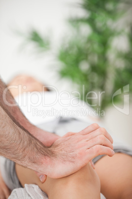 Serious doctor pressing on the knee of a woman