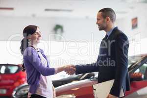 Salesman and a woman shaking hands