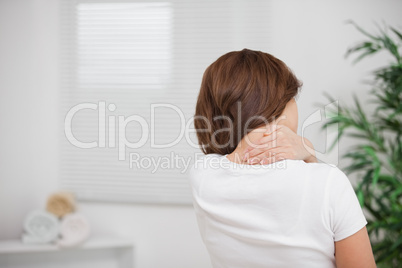 Woman massaging her painful nape