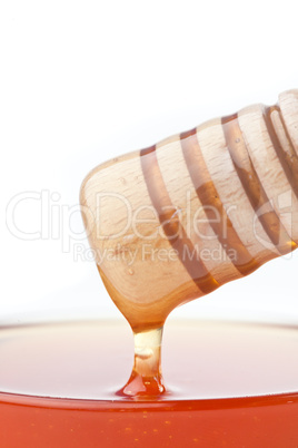 Close up of honey dipper on the top of a bowl