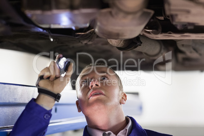 Mechanic holding a flashlight