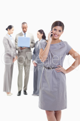 Businesswoman on the phone with a hand on her hip and the head t