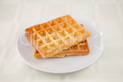 Two waffles on a saucer