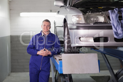 Front view of a smiling mechanic
