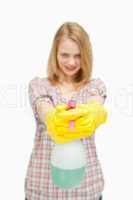 fair-haired woman holding a spray bottle