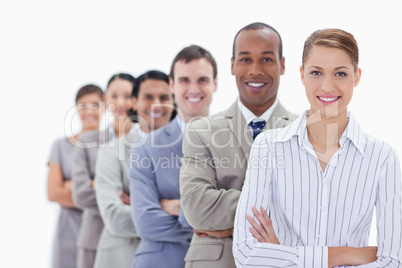 Close-up of smiling people dressed in suits crossing their arms