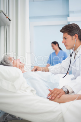 Doctor auscultating a patient with a stethoscope