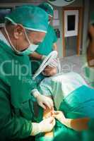Surgeon using a scalpel to open a patient