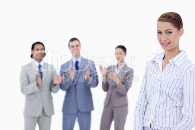 Close-up of a woman with business people applauding while watchi