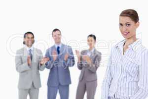 Close-up of a woman with business people applauding while watchi