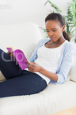 Black woman looking at a book
