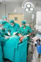 Surgeons and nurses around a patient
