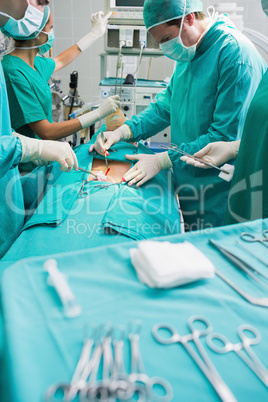 Focus on surgical team next to surgical tools