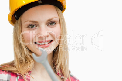 Close up of a woman holding a wrench