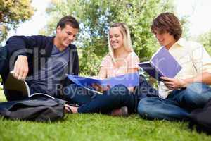 Low angle-shot of three students in a park
