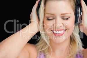 Smiling blonde woman wearing her headphones