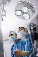 Doctors next to surgical light
