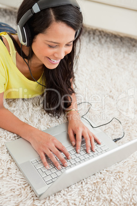 Close-up of a smiling Latin chatting on a laptop