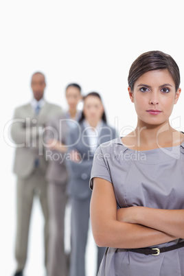 Close-up of a serious business team crossing their arms and stan