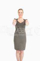 Woman standing while she is thumps up