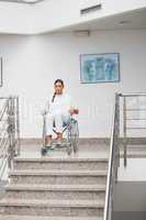 Female patient sitting on a wheelchair