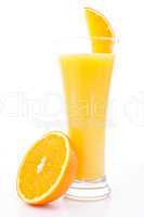 Half of am orange near a glass of orange juice