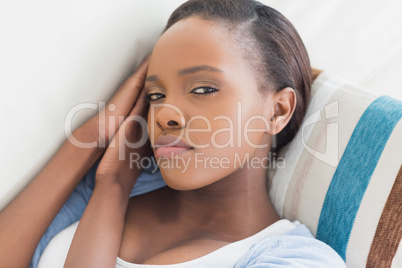 Black woman looking at camera while lying