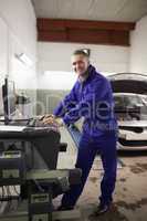 Mechanic using a computer while smiling