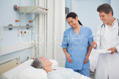 Doctor and nurse smiling to a patient
