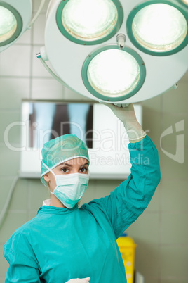 Surgeon holding a surgery light