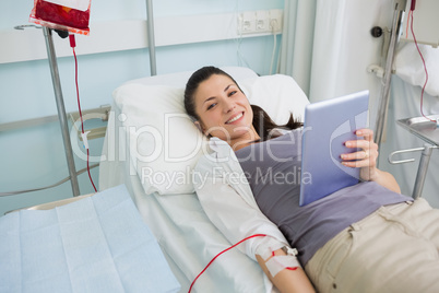 Smiling transfused holding a tablet computer Smiling transfused holding a tablet computer