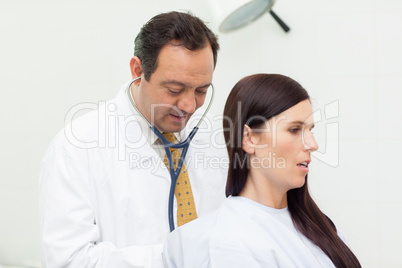 Patient being auscultated by a doctor
