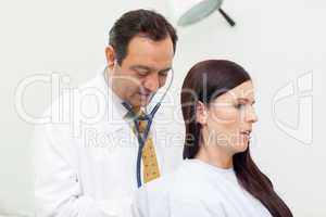 Patient being auscultated by a doctor