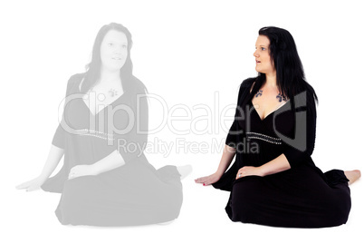 Young woman sitting on the floor and sees her own image