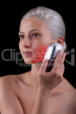 Young woman getting photo-therapy treatment with red light