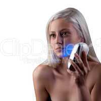 Young woman getting face phototherapy treatment by blue light