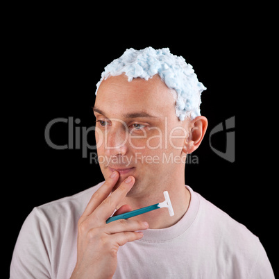 Shave or not to shave - young man with light blue shaving foam o