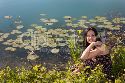 Young woman by the pond