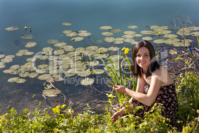 Young woman by the pond