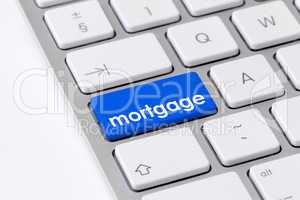 Keyboard with one blue button with the word mortgage