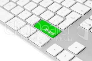 Computer keyboard with green learn button