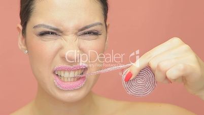 Beautiful woman eating coiled jelly