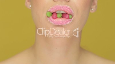 Woman with jelly beans in her mouth