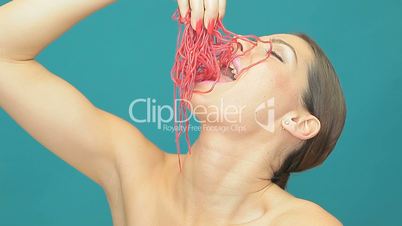 Beautiful woman eating strands of jelly