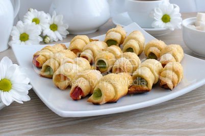 Plate with homemade croissants filled with colorful jelly